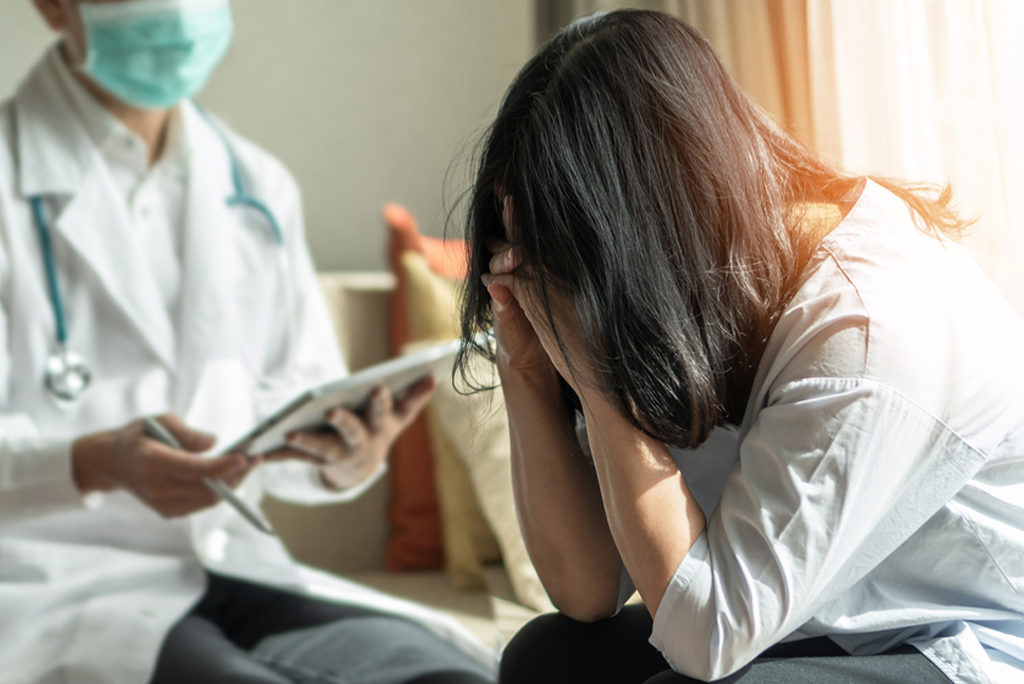 Healthcare professional comforting an anxious individual at Naveen Rehab Centre in Coimbatore, specializing in support for anxiety and panic attacks.