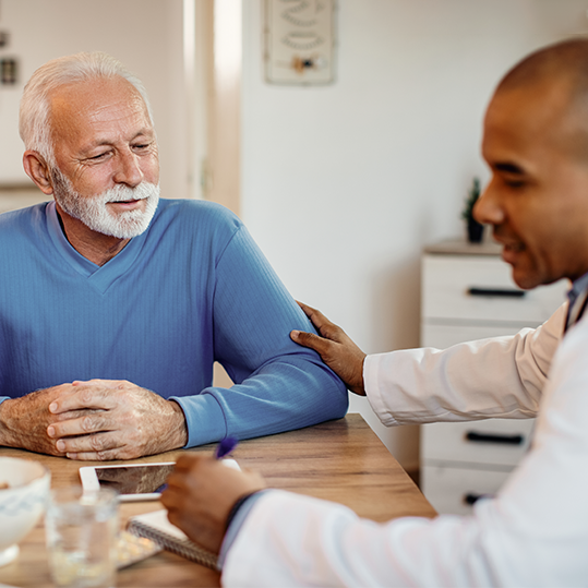 A healthcare professional comforting an elderly patient at Naveen Rehab Center in Coimbatore, showcasing personalized care.