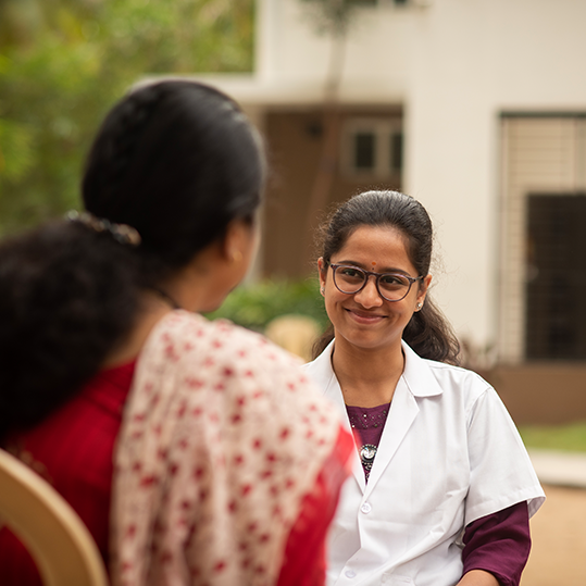 A smiling counselor engaging with a patient at Naveen Rehab Center in Coimbatore.