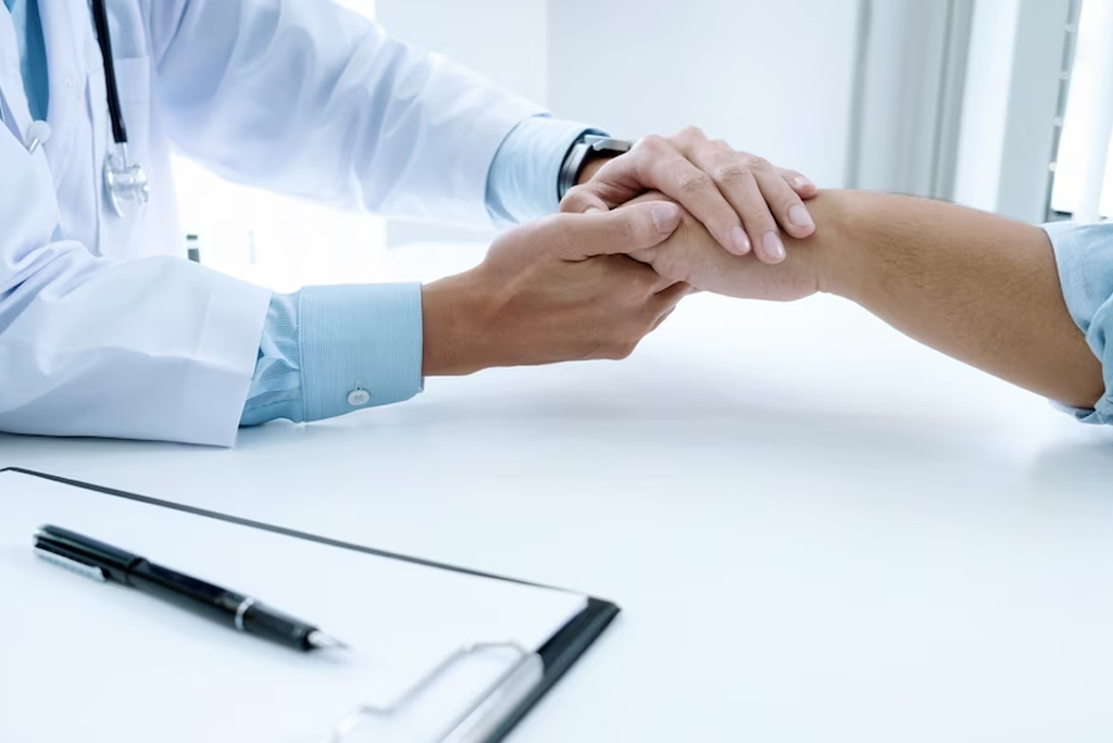 A healthcare professional at Naveen Rehab Center in Coimbatore comforting a patient with a reassuring hand gesture, offering support for those dealing with schizophrenia.