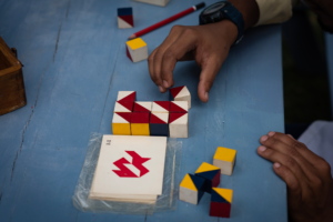 Patient engaging in cognitive therapy using colorful geometric puzzles at Naveen Rehab Center in Coimbatore.